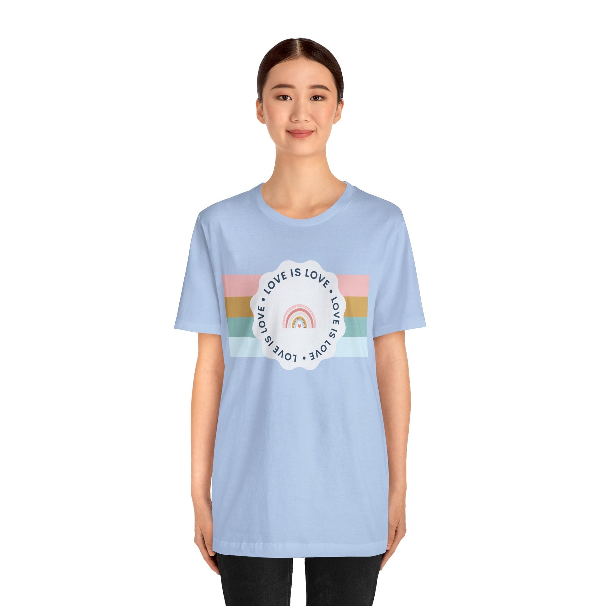 Pastel blue Pride T-shirt showcasing colorful “Love Is Love” lettering—playful, inclusive, and ideal for Pride festivities.
