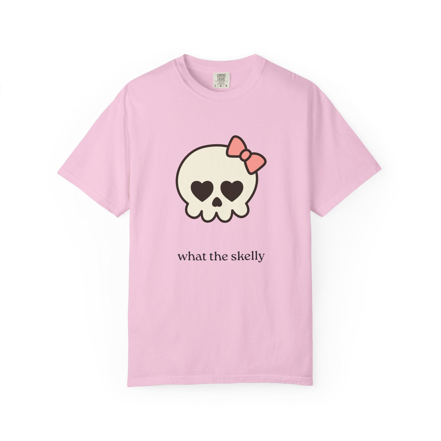 Pink tee featuring wide-eyed skeleton and cheeky “What the Skelly?” text, perfect for fall fun and cozy October outfits.