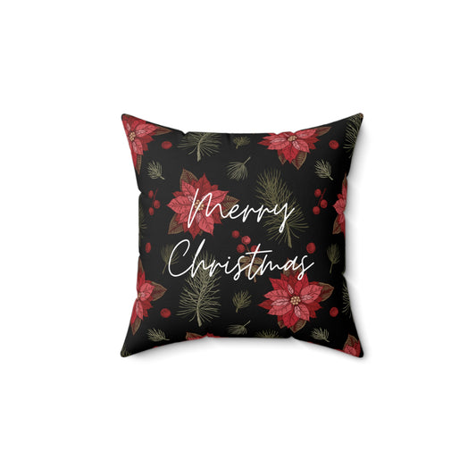 Flat lay of elegant Christmas pillow featuring red poinsettia flower and holiday script design on cream fabric