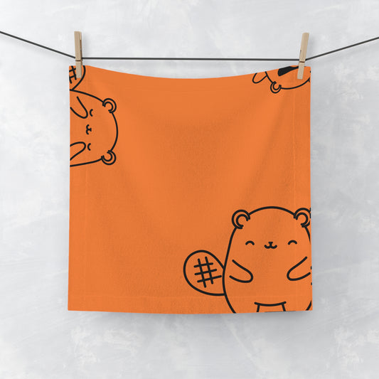Orange face towel with playful beaver motif, laid flat on white surface