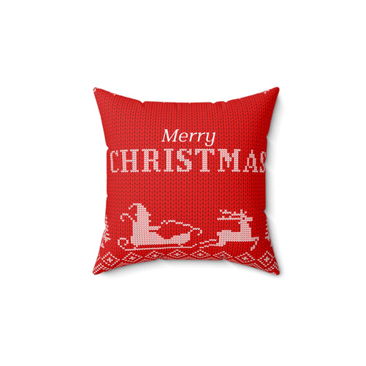 Flat lay of red Christmas pillow with bold 'Merry Christmas' script and Santa-inspired trim on soft surface with holiday props