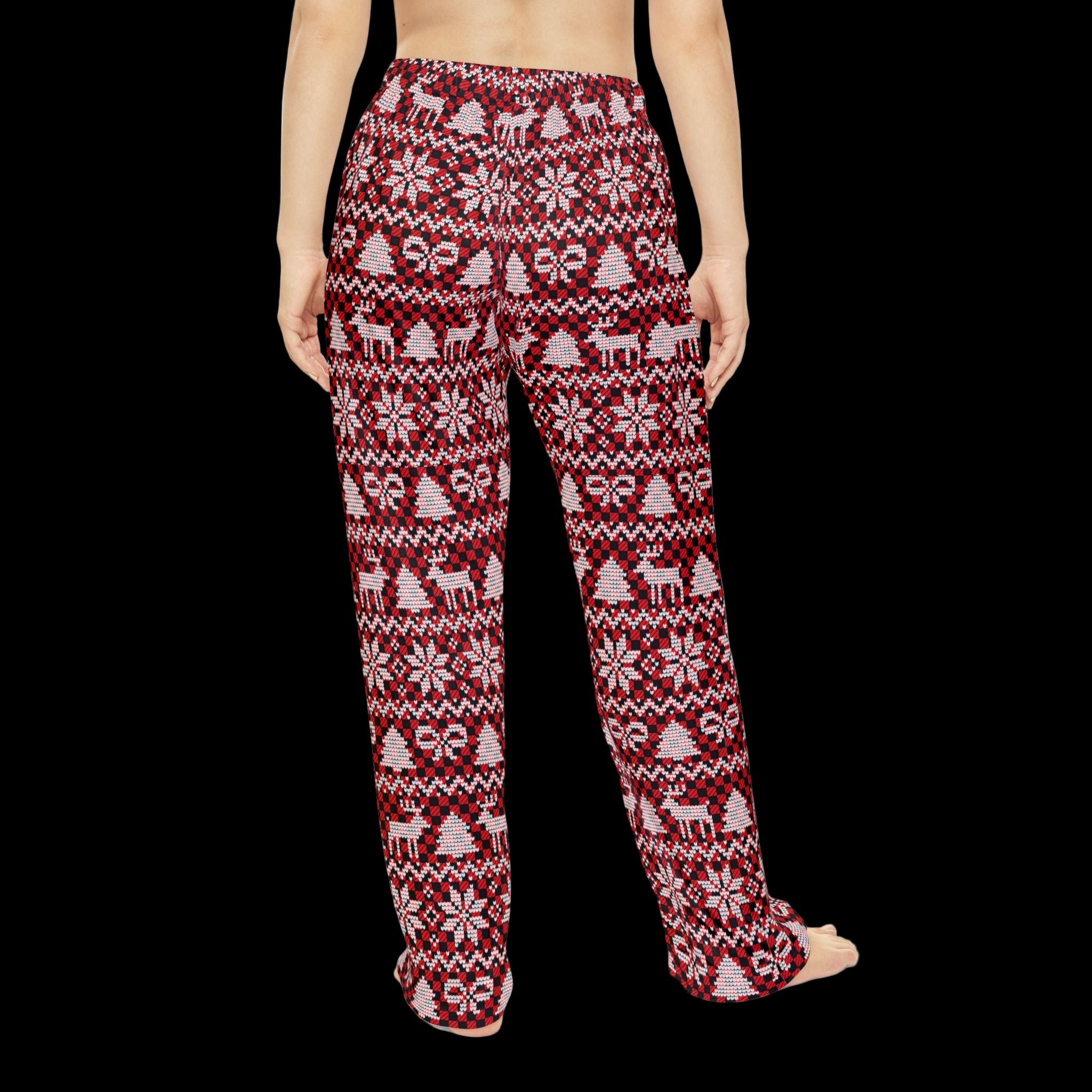Red Christmas sweater pajama pants worn beside a decorated Christmas tree for festive lounging.