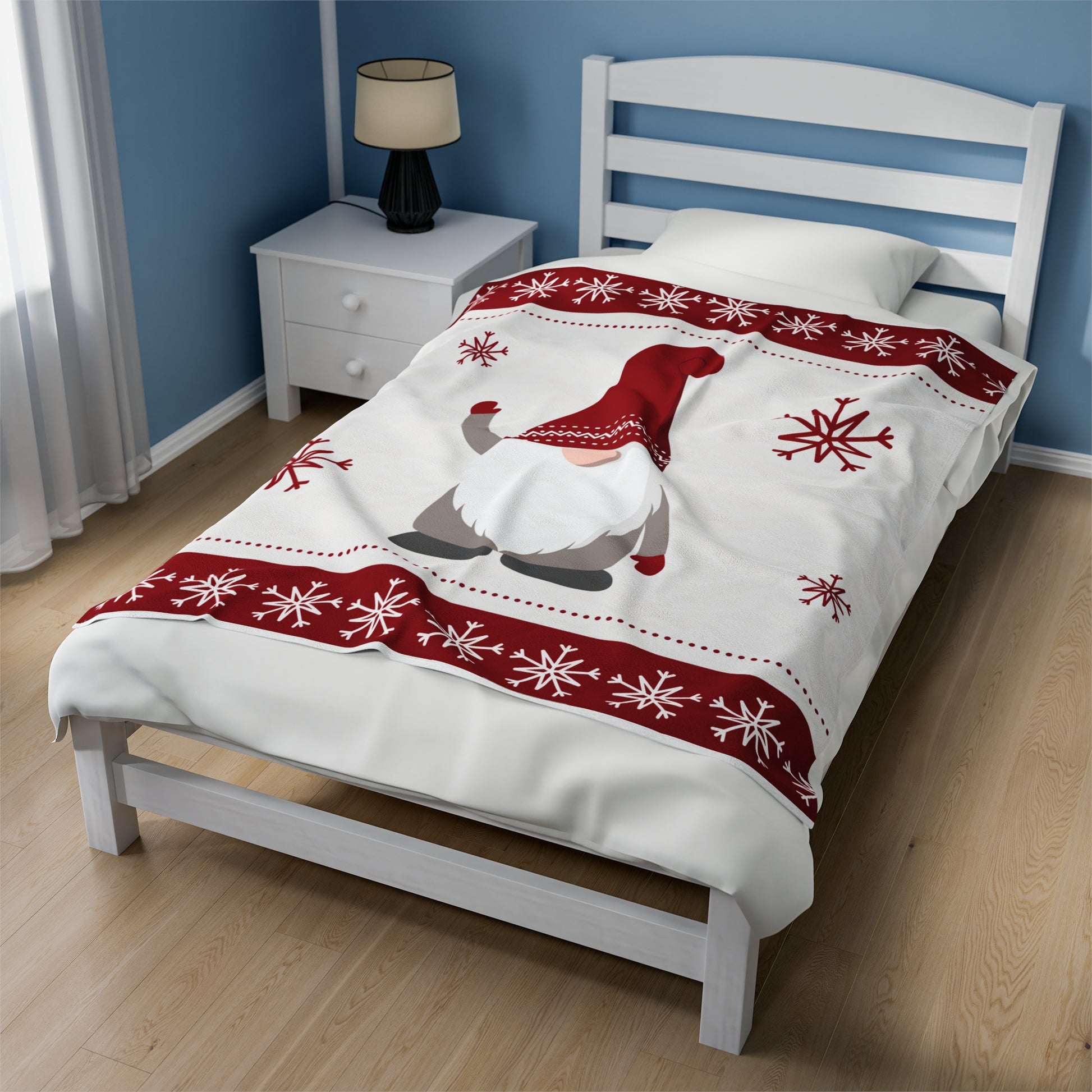 Red and white Christmas blanket featuring gnome illustrations draped over festive sofa with twinkle lights and holiday pillows"