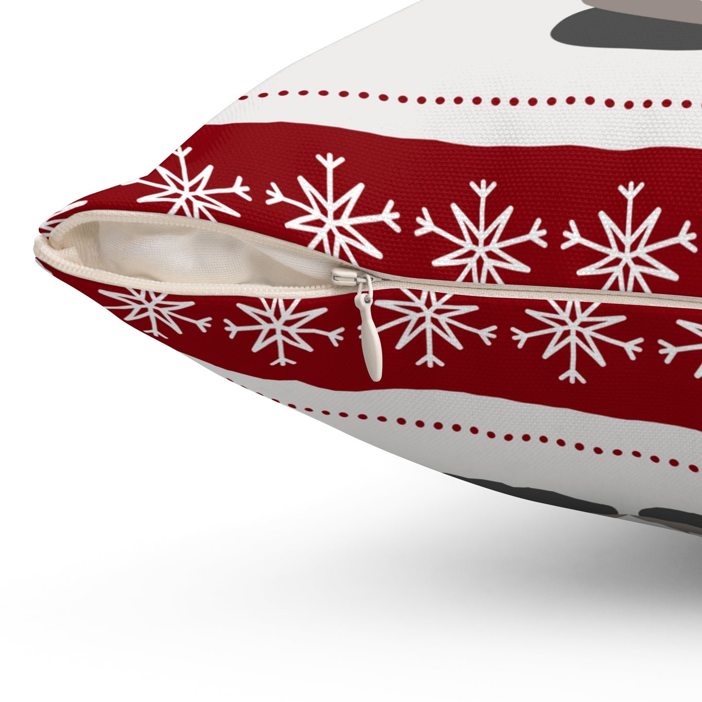 Close-up view of hidden zipper on back of red and white holiday pillow with durable stitching and soft fabric texture