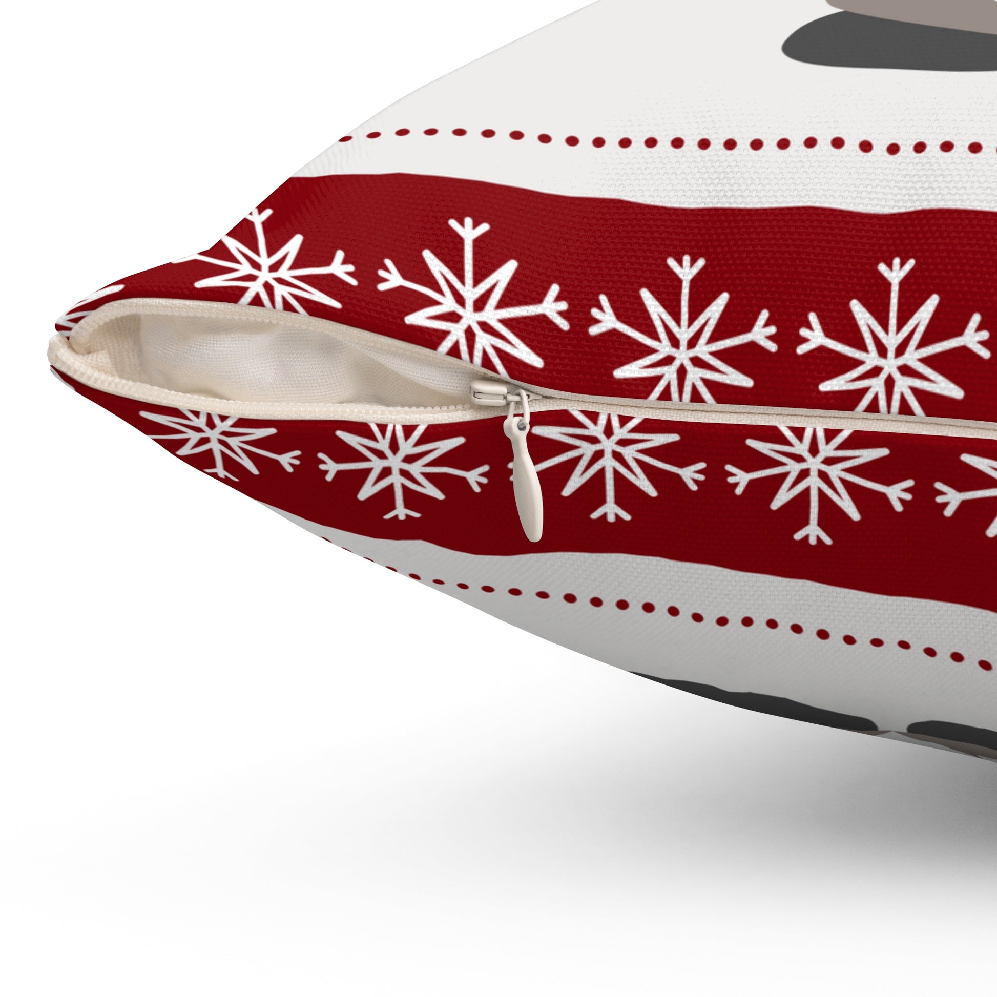 Close-up view of hidden zipper on back of red and white holiday pillow with durable stitching and soft fabric texture