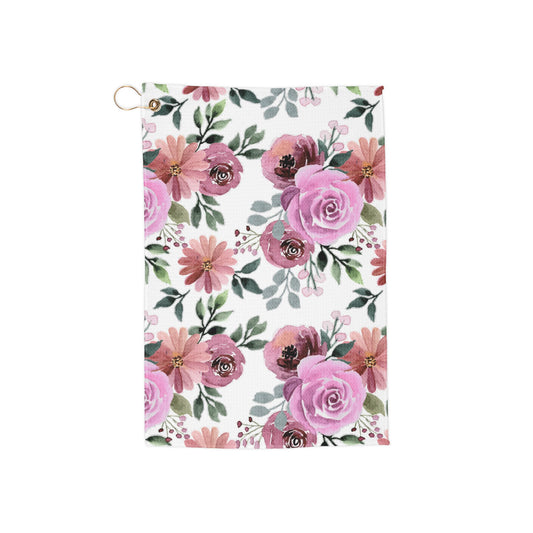 A soft blush pink golf towel adorned with delicate floral accents, bringing a dreamy, romantic aesthetic to the course.