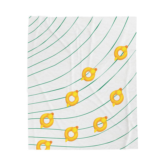 Wavy patterned plush blanket with scattered rubber duckies styled for college dorm decor