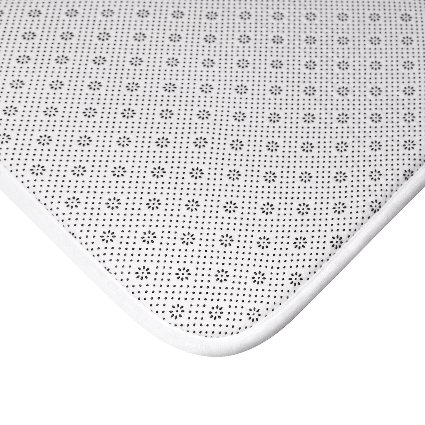 Close-up of soft bath mat texture featuring playful duck design and ripple motif