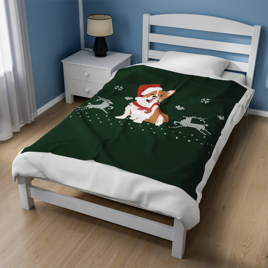 Festive holiday blanket featuring corgi in Santa hat draped over a cozy Christmas couch with twinkle lights and holiday pillows