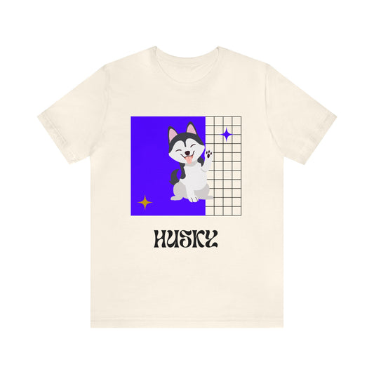 Soft cream shirt with playful husky mascot graphic, modeled outdoors with retro sunglasses and gameday-ready flair.