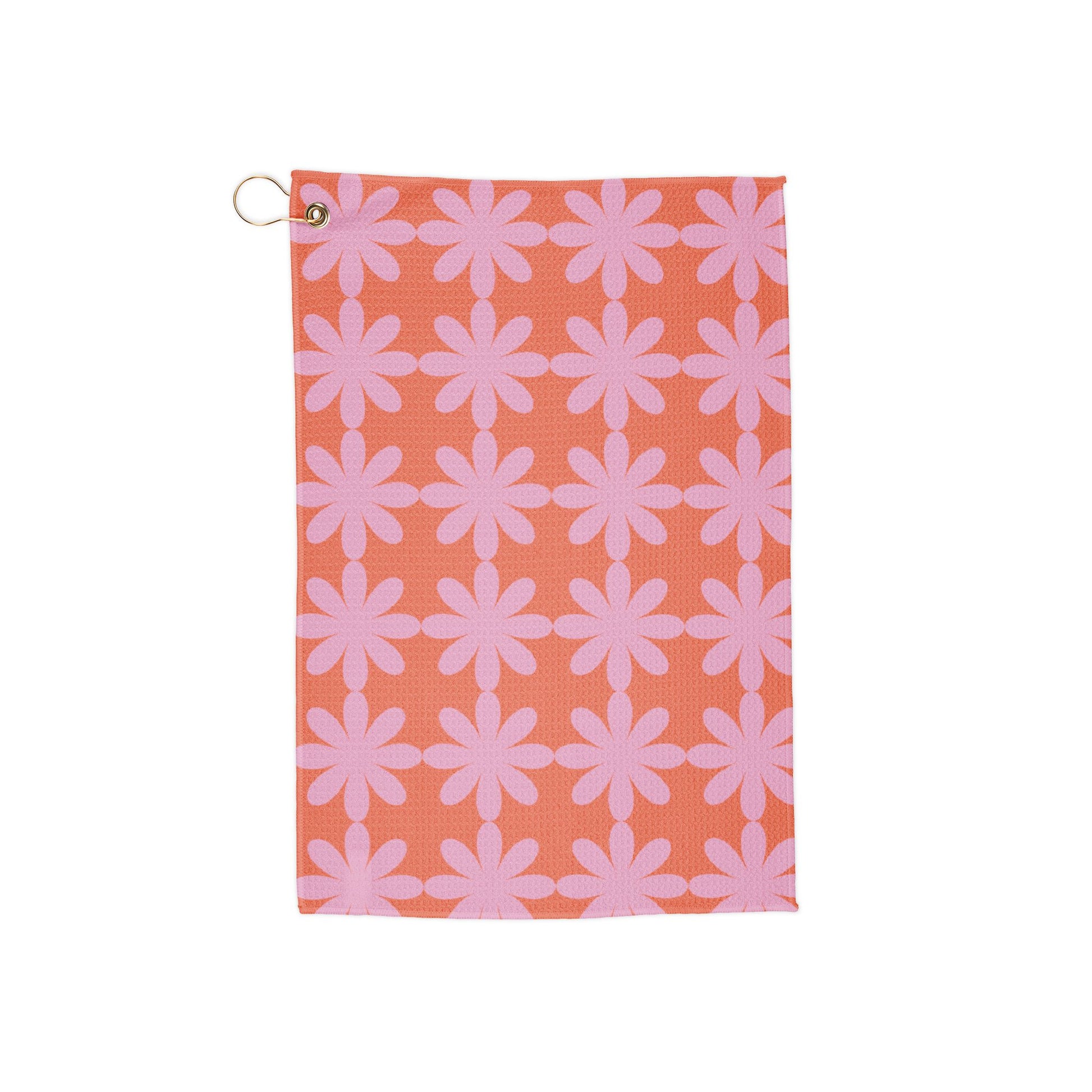 A dreamy pink golf towel with star-shaped floral patterns. A fusion of soft hues and funky retro flair—perfect for making a statement on the course.