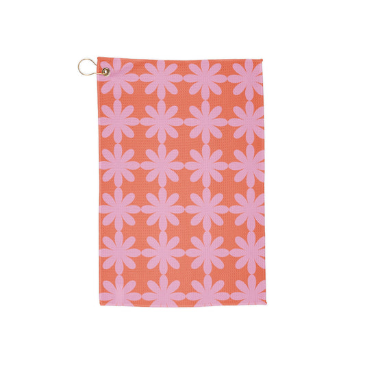 A dreamy pink golf towel with star-shaped floral patterns. A fusion of soft hues and funky retro flair—perfect for making a statement on the course.