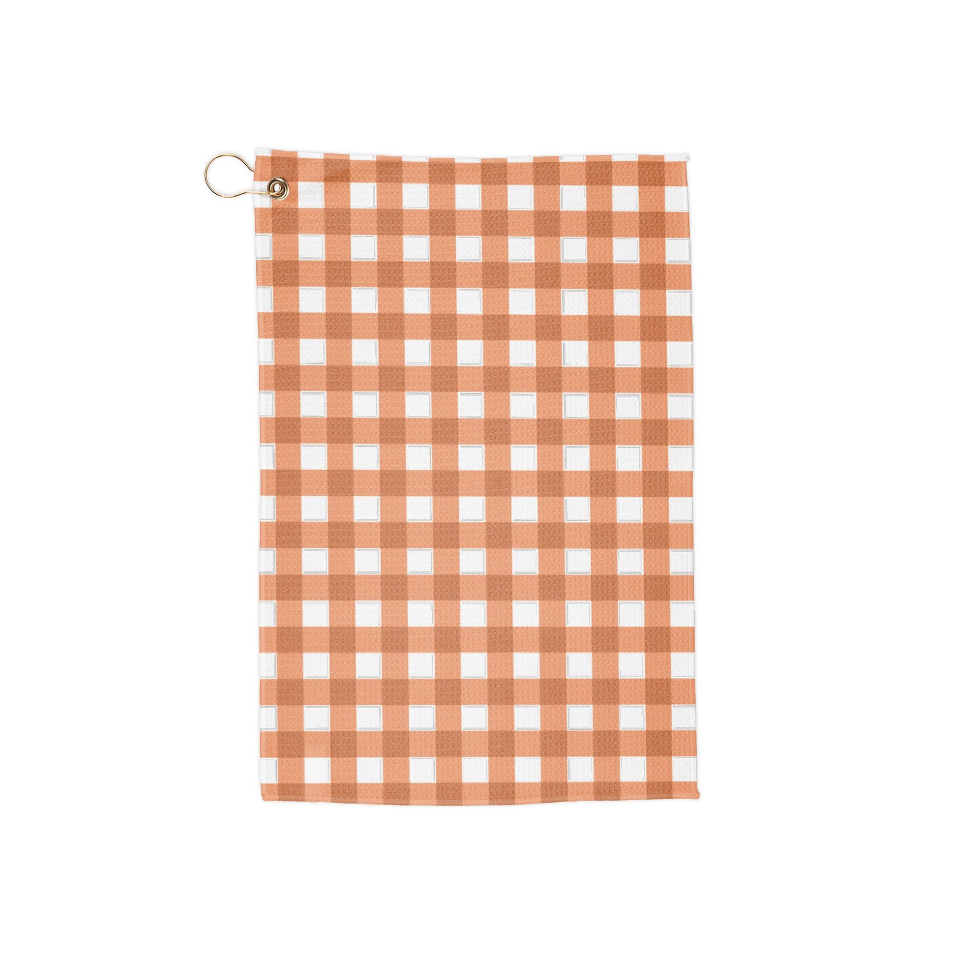 A bright orange gingham golf towel with warm, citrusy tones. A funky, retro nod to classic summer vibes on the course.