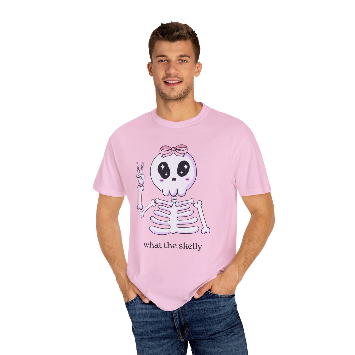 Pink Halloween tee with “What the Skelly” skeleton graphic, styled for playful spooky season fans.