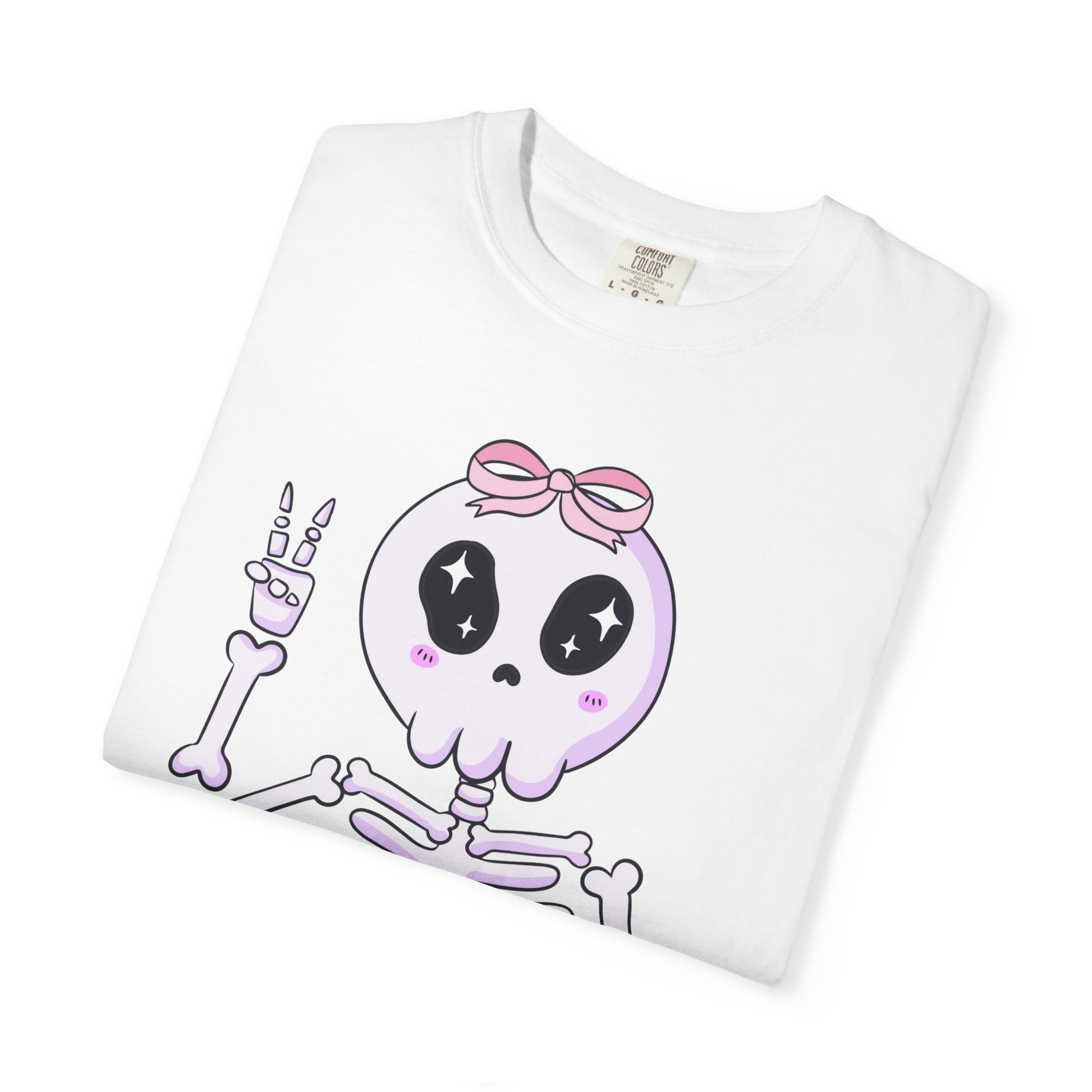 White tee with playful skeleton illustration and “What the Skelly” text, perfect for spooky season layering.