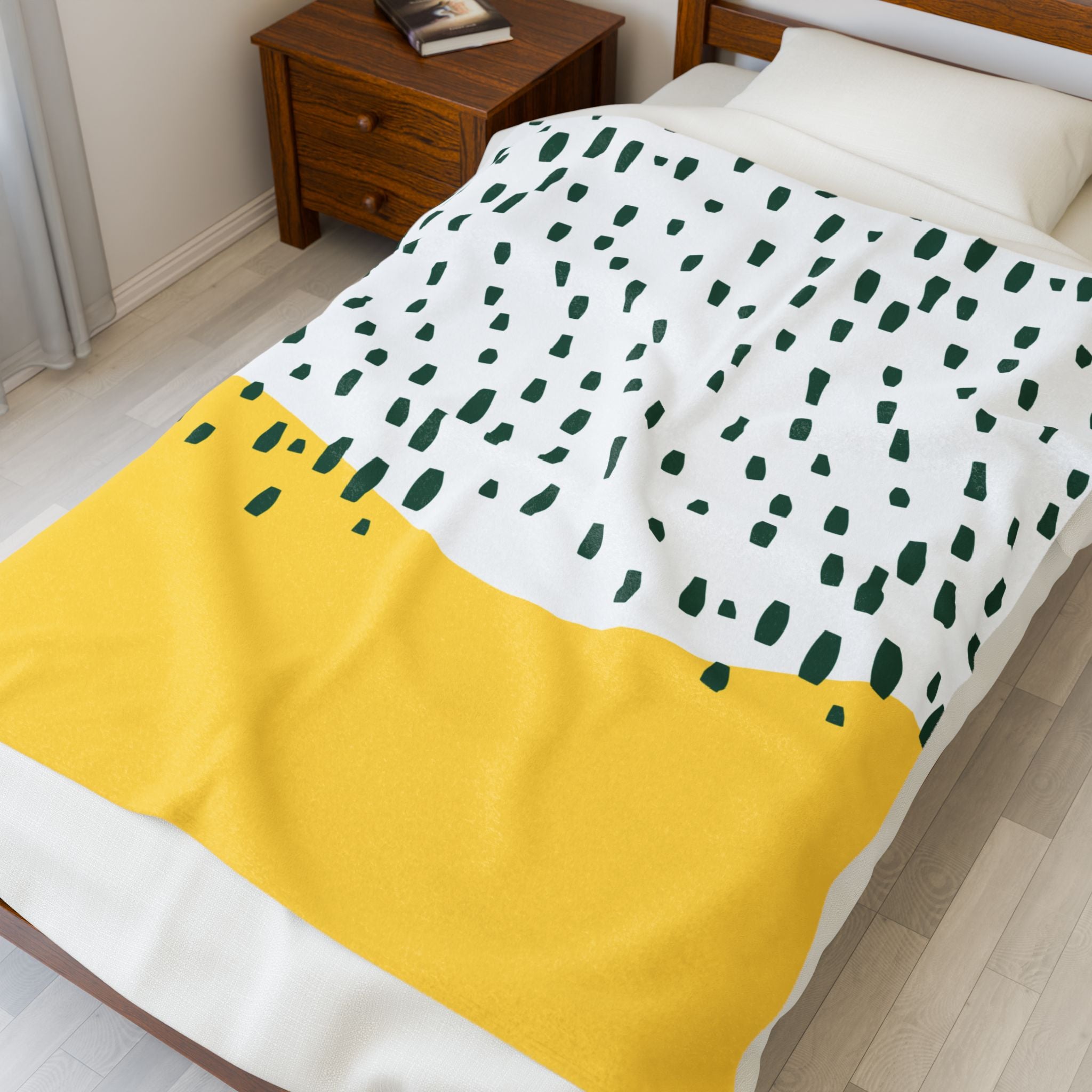 Folded plush blanket in retro rain theme showing olive and golden tones